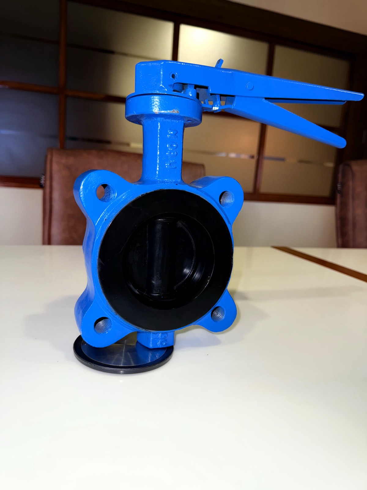 Side view of Supreme branded neck and lever on blue WCB lug butterfly valve